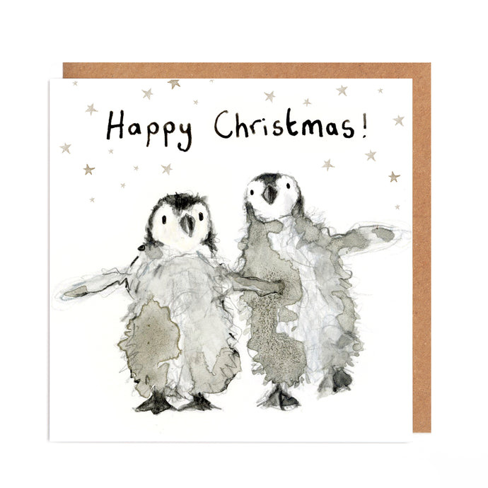 Square white Christmas card featuring watercolour and pencil illustration of a two fluffy baby penguins surrounded by stars, and handwritten 'Happy Christmas!' message.