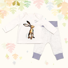 Load image into Gallery viewer, Baby gift set comprising a white top featuring an illustrated hare print and matching bottoms with dusky heather purple cuffs, on a backdrop of pastel leaves.