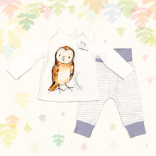 Load image into Gallery viewer, Baby gift set comprising a white long-sleeved top featuring an illustrated owl print and matching bottoms with purple cuffs, on a backdrop of pastel leaves. 