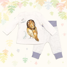 Load image into Gallery viewer, Baby gift set comprising a white long-sleeved top showing back of an illustrated owl print and matching bottoms with purple cuffs, on a backdrop of pastel leaves. 