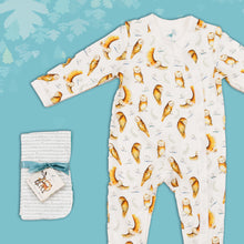 Load image into Gallery viewer, Baby gift set comprising a white babygrow featuring an illustrated repeat print of owls and dragonflies alongside matching dribble cloths tied in turquoise ribbon, on a blue backdrop with decorative  leaves. 