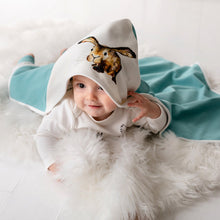 Load image into Gallery viewer, Baby lying down on their tummy wearing Molly hare hooded blanket with turquoise reverse.