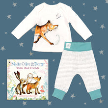 Load image into Gallery viewer, Baby gift set featuring a book from the Molly, Olive and Dexter series by Catherine Rayner, &#39;Three Best Friends&#39;, and a matching fox pyjama set laid on a midnight blue backdrop with silver stars. The pyjama set comprises a white long-sleeved top featuring an illustrated wraparound fox print and matching bottoms with blue cuffs.