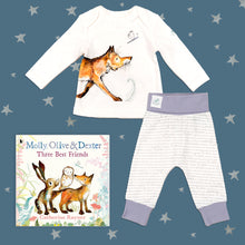 Load image into Gallery viewer, Baby gift set featuring a book from the Molly, Olive and Dexter series by Catherine Rayner, &#39;Three Best Friends&#39; and a matching fox pyjama set laid on a midnight blue backdrop with silver stars. The pyjama set comprises a white long-sleeved top featuring an illustrated wraparound fox print and matching bottoms with purple cuffs.