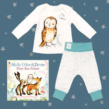 Load image into Gallery viewer, Baby gift set featuring a book from the Molly, Olive and Dexter series by Catherine Rayner, &#39;Three Best Friends&#39;, and a matching owl pyjama set laid on a midnight blue backdrop with silver stars. The pyjama set comprises a white long-sleeved top featuring an illustrated wraparound owl print and matching bottoms with blue cuffs.