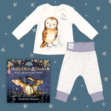 Load image into Gallery viewer, Baby gift set featuring a book from the Molly, Olive and Dexter series by Catherine Rayner, &#39;Who&#39;s Afraid of the Dark?&#39;, and a matching owl pyjama set laid on a midnight blue backdrop with silver stars. The pyjama set comprises a white long-sleeved top featuring an illustrated wraparound owl print and matching bottoms with purple cuffs.