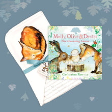 Load image into Gallery viewer, Baby gift set featuring a book from the Molly, Olive and Dexter series by Catherine Rayner, &#39;The Guessing Game&#39;, and a matching fox blanket laid on a dusty blue backdrop with pastel leaves. The blanket has a hood featuring a fox curled up for sleep and is wrapped with a turquoise ribbon. 