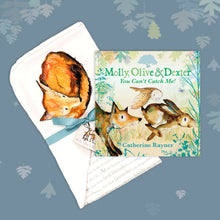 Load image into Gallery viewer, Baby gift set featuring a book from the Molly, Olive and Dexter series by Catherine Rayner, &#39;You Can&#39;t Catch Me!&#39;, and a matching fox blanket laid on a dusty blue backdrop with pastel leaves. The blanket has a hood featuring a fox curled up for sleep and is wrapped with a turquoise ribbon. 