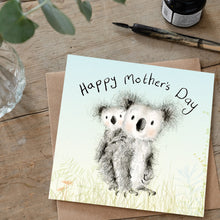 Load image into Gallery viewer, A Mother&#39;s Day Card featuring a watercolour pencil illustration of a mummy and baby Koala laid on a tabletop alongside an ink pot and dip pen and some eucalyptus.