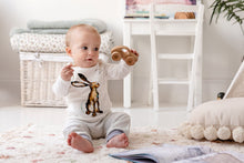 Load image into Gallery viewer, One year old baby sat up wearing the Molly Hare top and matching story-time joggers with dusky heather purple trim. 