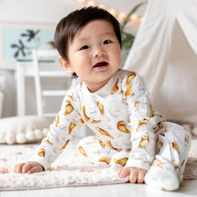 Load image into Gallery viewer, One year old baby sat leaning forward wearing the illustrated Olive Owl Babygrow.