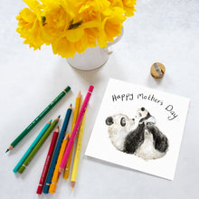 Load image into Gallery viewer, A Mother&#39;s Day Card featuring a watercolour pencil illustration of a mummy and baby panda laid on a tabletop alongside some daffodils and coloured pencils. 