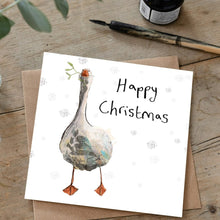 Load image into Gallery viewer, Illustrated Clara Goose christmas card and matching brown envelope laid flat on a wooden table beside dip pen and ink. 