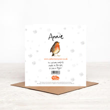 Load image into Gallery viewer, Square robin christmas card stood on matching brown craft envelope, showing reverse side including details about charity partner Read for Good