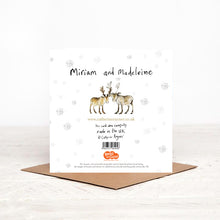 Load image into Gallery viewer, The reverse side of Miriam and Madeleine baby Reindeer Christmas card, featuring handwritten details. snowflakes and details of Christmas charity partner, children&#39;s literacy charity Read for Good.