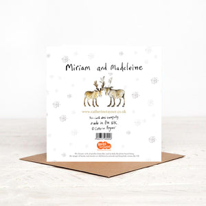 The reverse side of Miriam and Madeleine baby Reindeer Christmas card, featuring handwritten details. snowflakes and details of Christmas charity partner, children's literacy charity Read for Good.