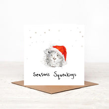 Load image into Gallery viewer, Square illustrated guinea pig Christmas card stood on matching brown craft envelope. 